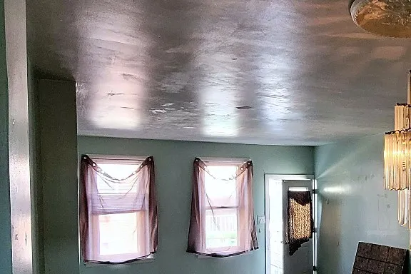 Before: the front room, from a crystal chandelier and dark laminate to recessed lights and wide-plank oak