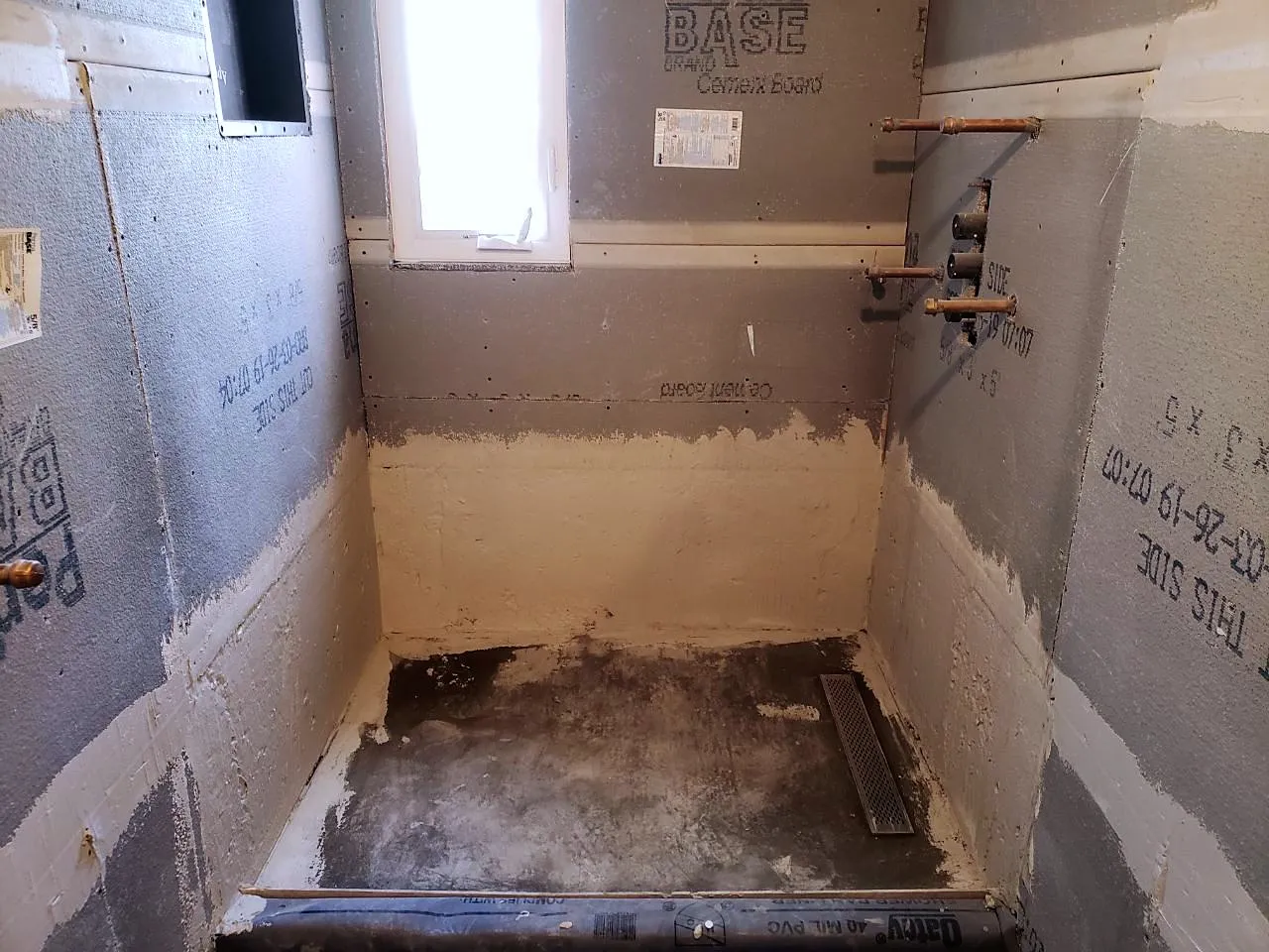 Cement board installed on the shower walls and pan