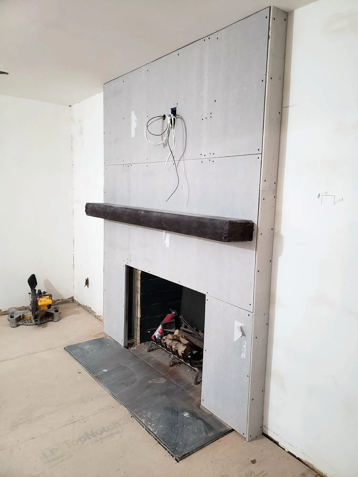 Fireplace chase framed and boarded with mantel in place during construction