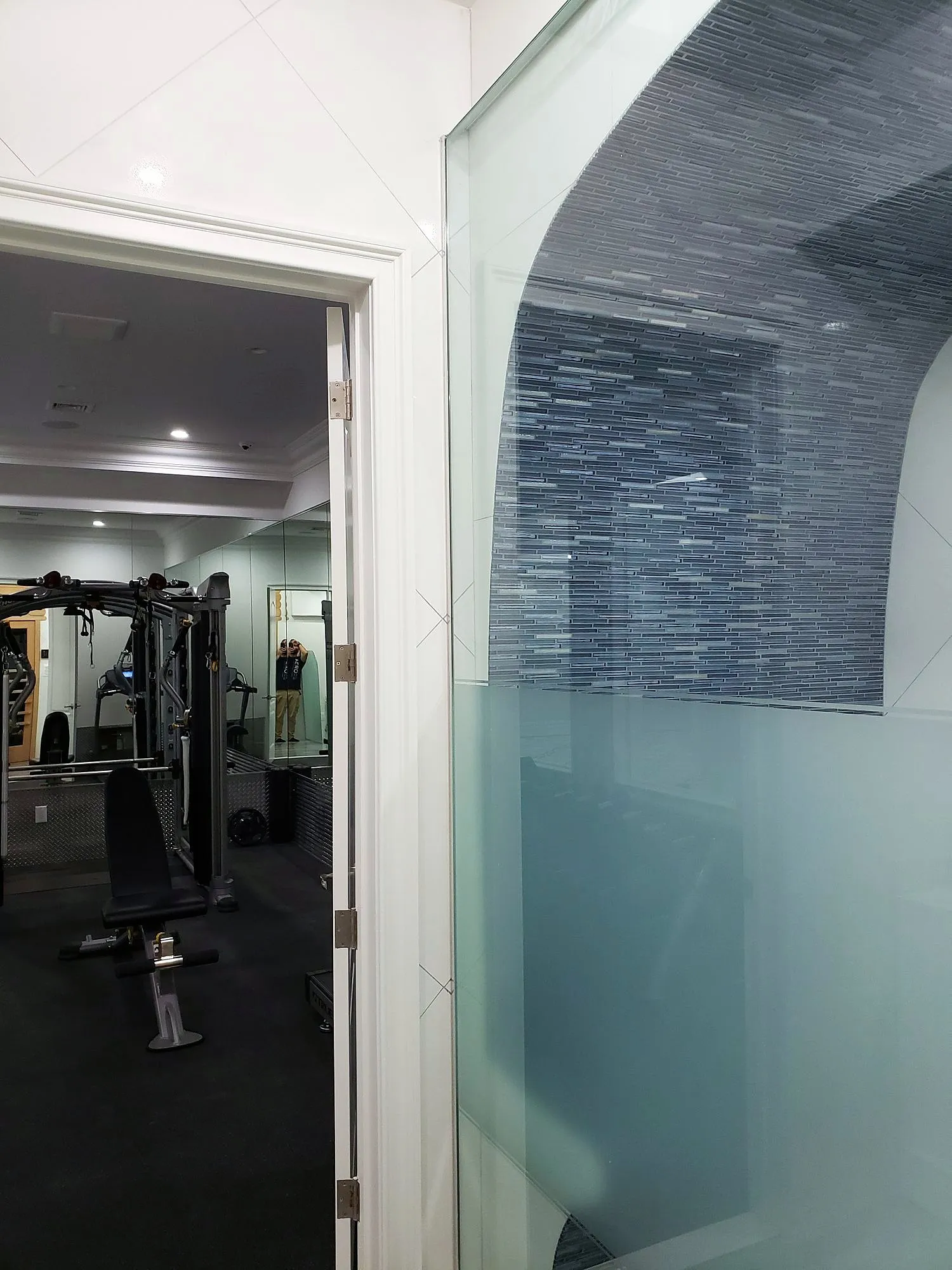 View from the shower through frosted glass toward a home gym
