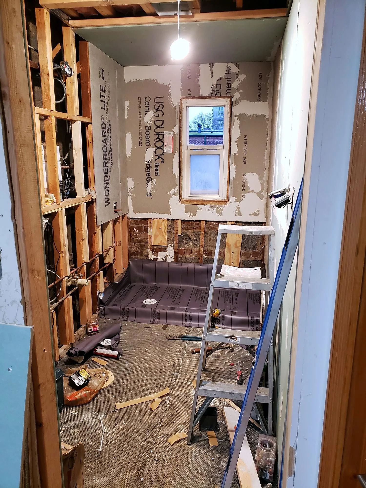Bathroom stripped to the studs with new blocking and a window opening