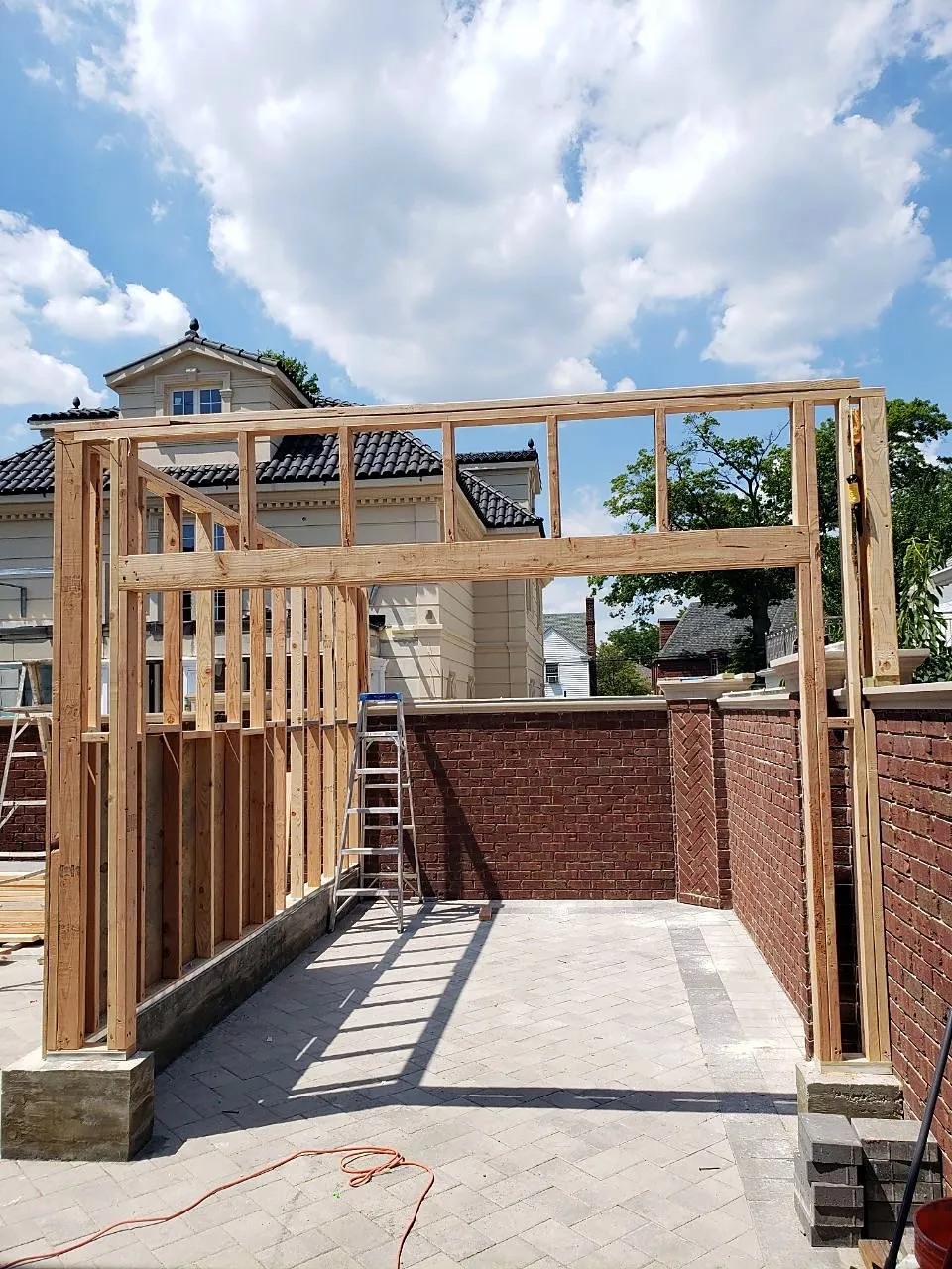 Garage roof framing against a blue sky