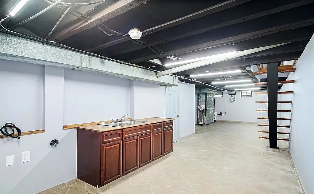 Finished basement with a second cabinet and sink run