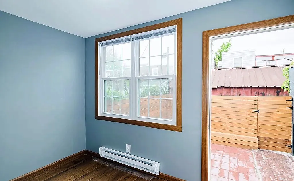 Rear room with a large window, a patio door and painted walls