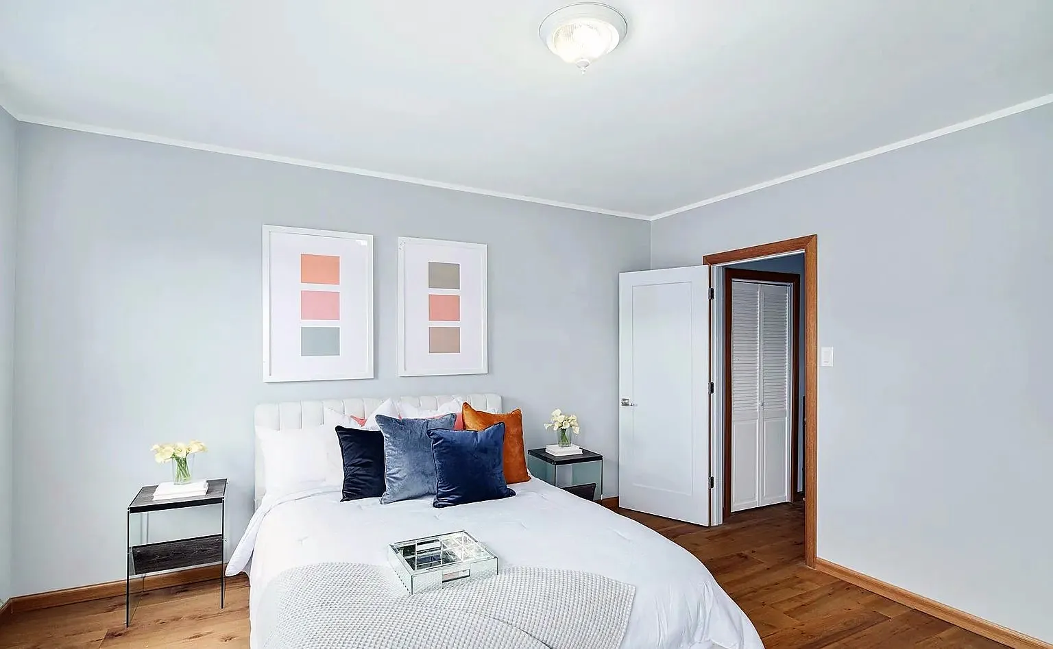 Bedroom with pale blue walls and white crown molding