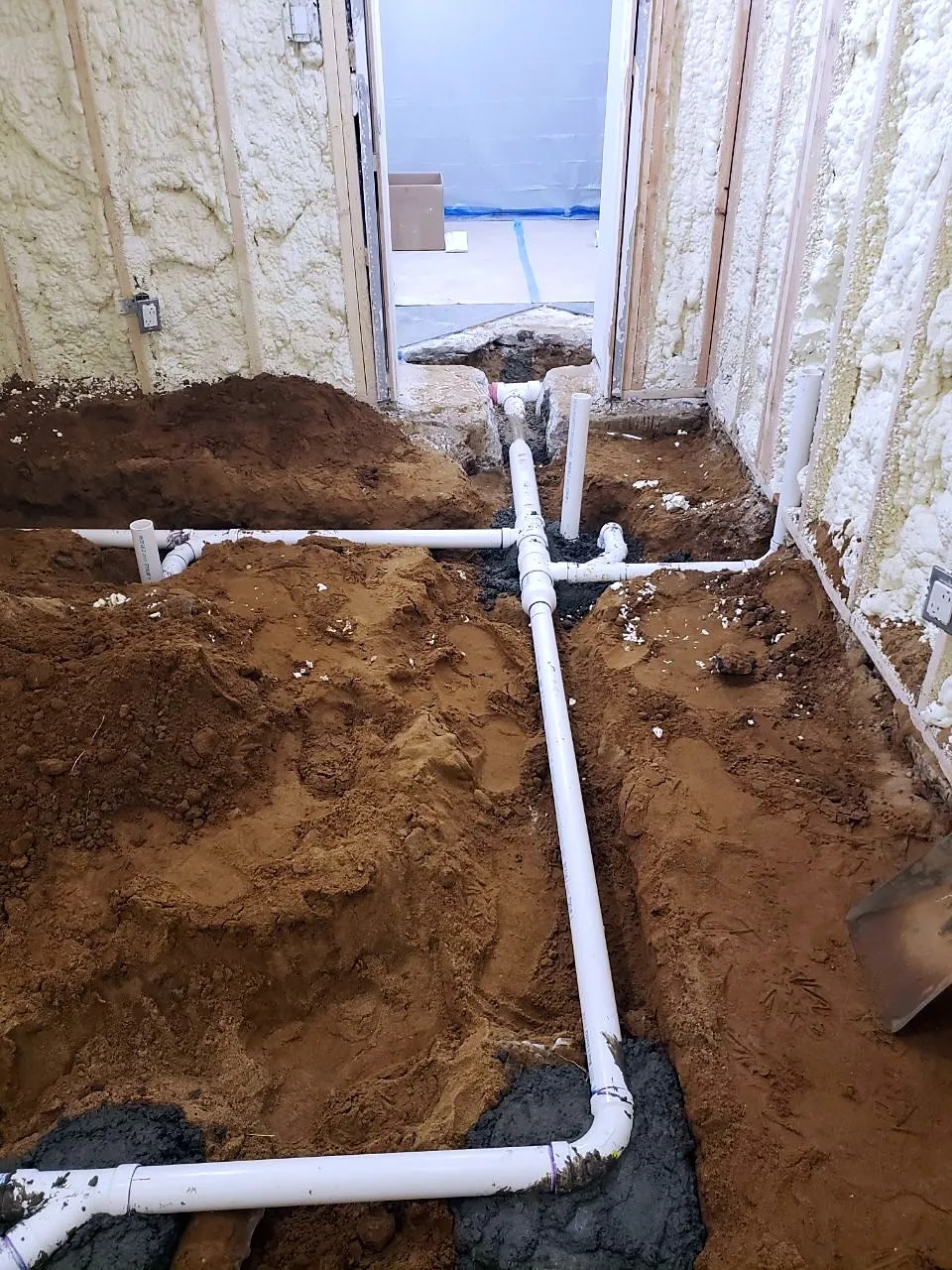 PVC drain and vent lines laid in a slab trench