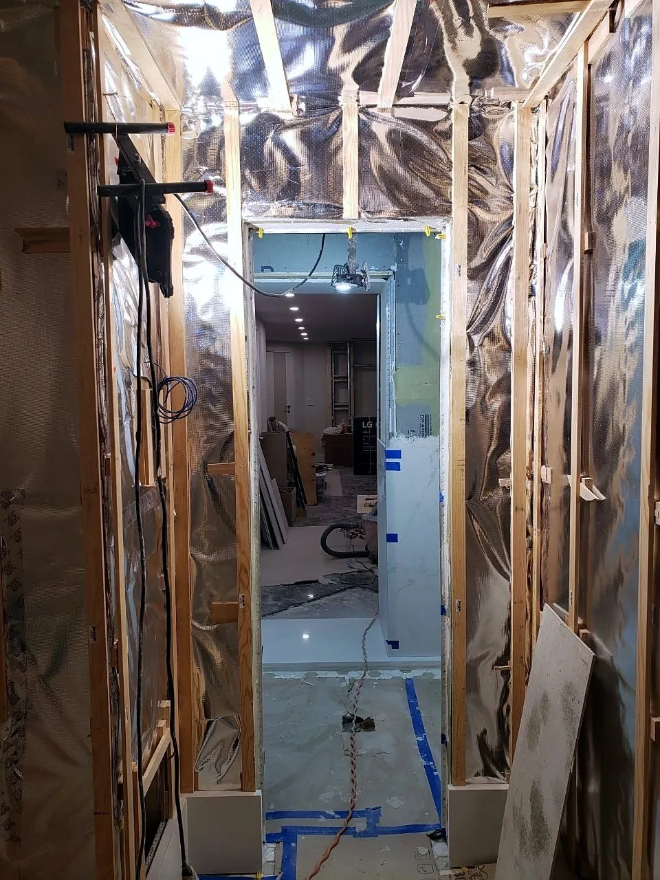 Sauna framing covered in foil vapor barrier