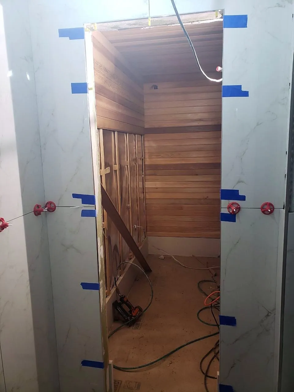 Cedar lining going up inside the sauna with the door frame set
